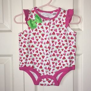 Onesie with ruffles and bow.
